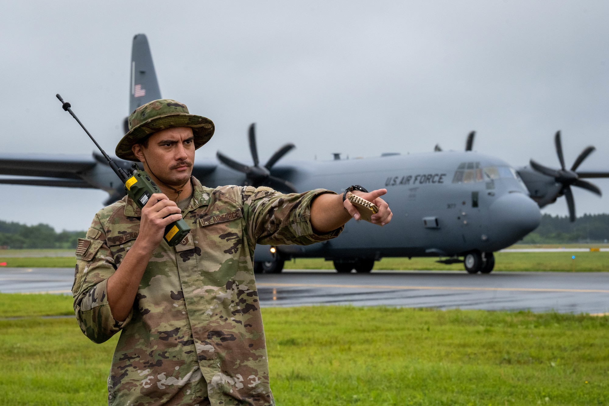 U.S. Air Force Tech. Sgt. Nelson Guerra, 36th Operations Support Squadron Landing Zone Safety Officer (LZSO) course participant, communicates with a C-130 Hercules over radio during the first ever LZSO course at Misawa Air Base, Japan, July 26, 2024.