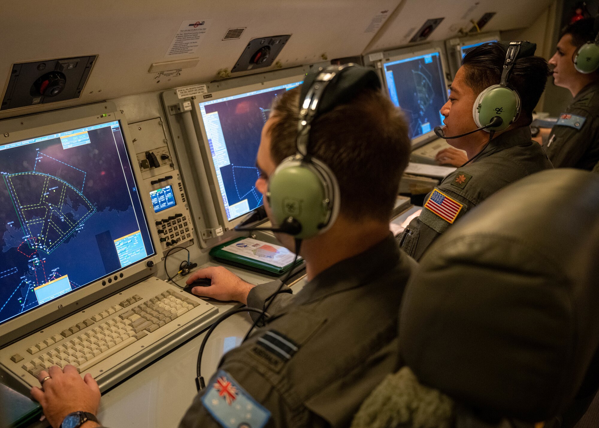 Photo of U.S. Air Force and Royal Australian Air Force air battle managers monitoring their systems