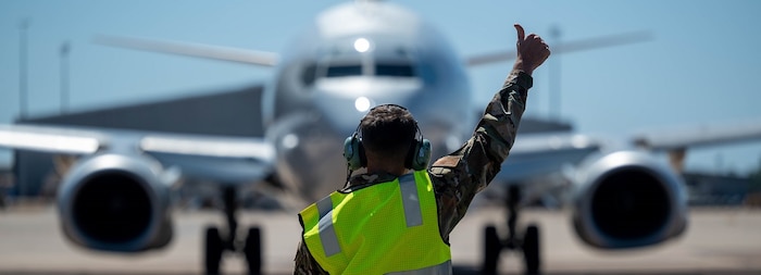 U.S. Air Force Staff Sgt. Ian Mclain, 2 Squadron E-7A Wedgetail Avionics technician, marshals an aircraft for a flight at Royal Australian Air Force Base Darwin, Australia, July 17, 2024.