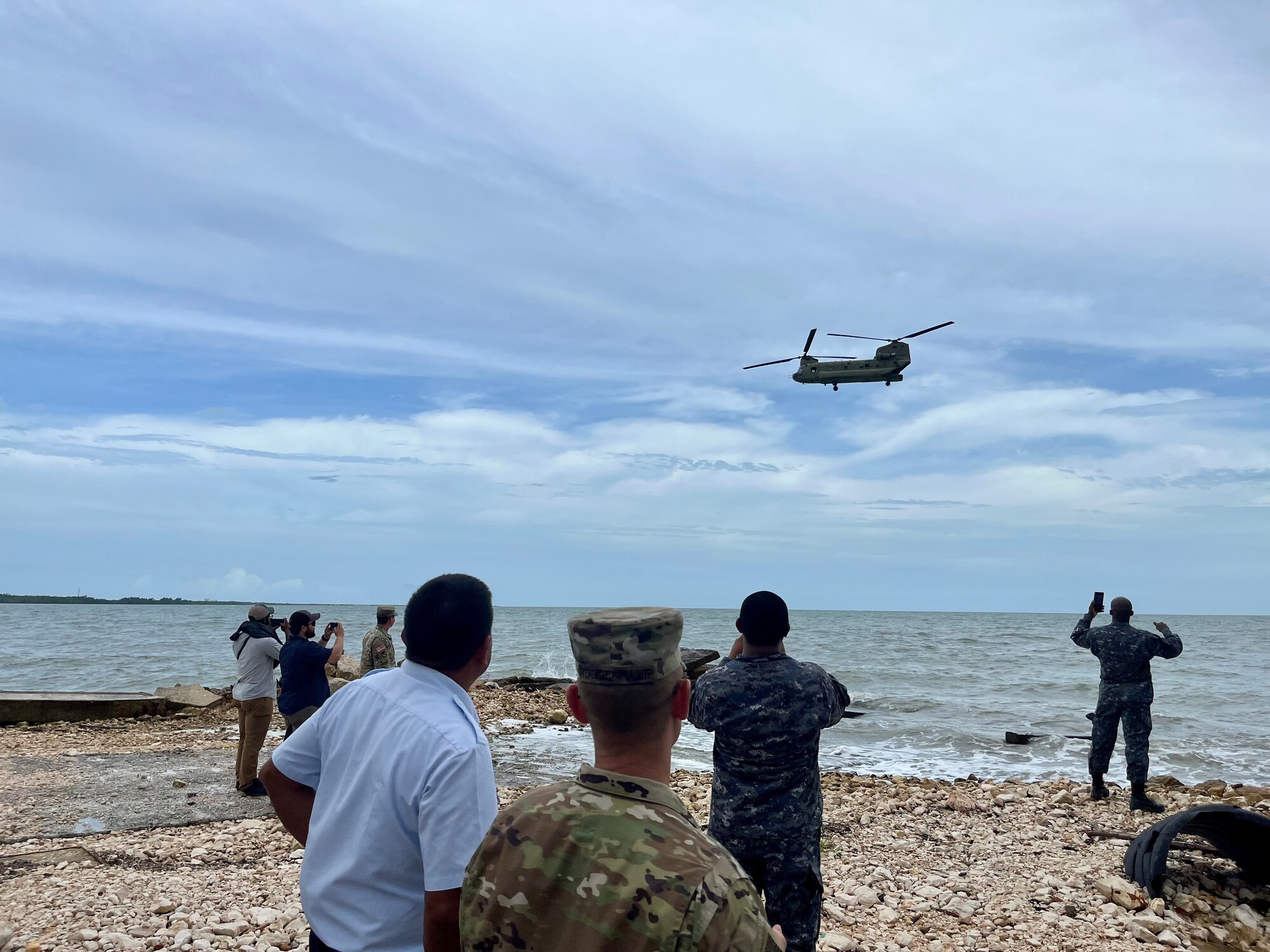 A photo of people watching a helicopter.