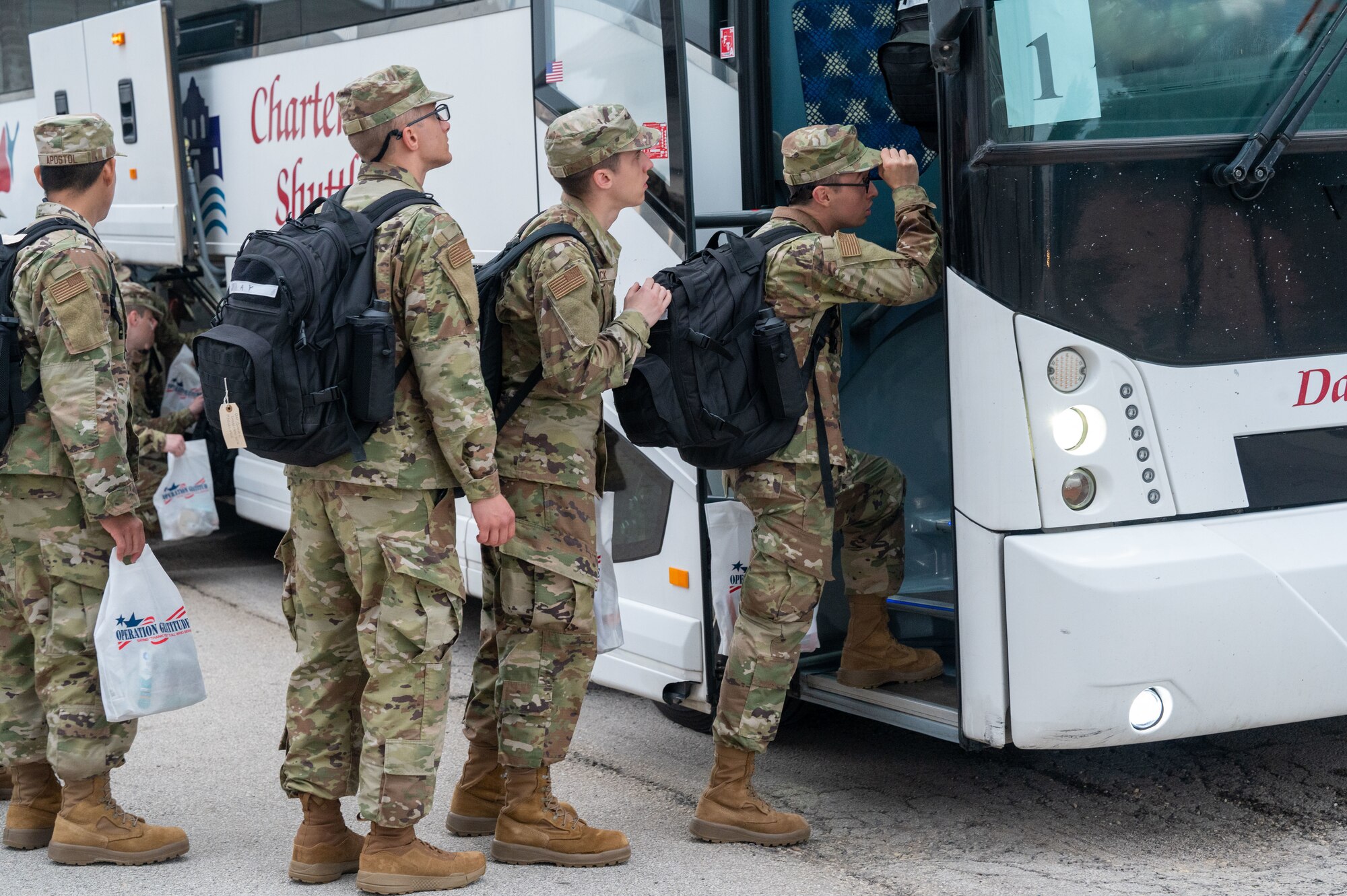 Airmen board a bus with their belongings that will take them to their different technical training school locations across the country on April 19, 2024. Each Friday morning, Airmen who graduated from Basic Military Training the day before, arrive at the Pfingston Reception Center to depart to their technical training schools where they will learn how to thrive in their specific jobs.