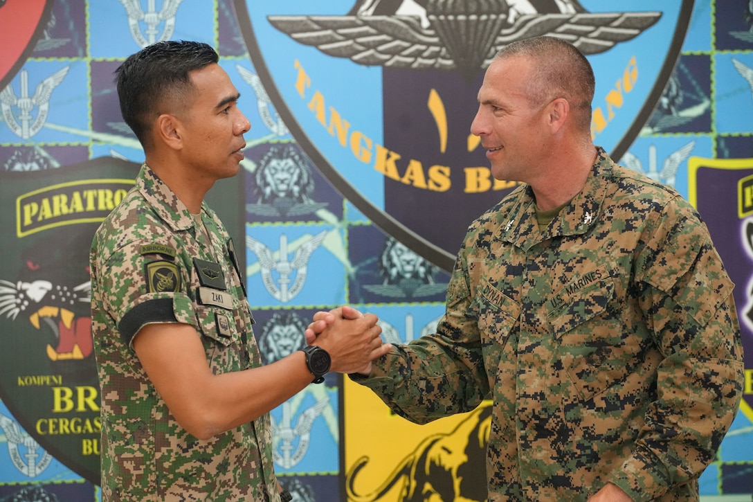 U.S. Marine Corps Col. Sean Dynan, right, commanding officer of the 15th Marine Expeditionary Unit gifts his command challenge coin to Malaysia Army Lt. Col. Mohd Zaki, commanding officer of 18th Battalion, Royal Malay Regiment, 10th Brigade (Para), during a key leader engagement at Sri Pantai Camp, Kuala Terengganu, Malaysia, May 28, 2024. Tiger Strike is a bilateral exercise between U.S. and Malaysia armed forces designed to enhance communication and build combat readiness through combined amphibious operations and subject matter expert exchanges in support of a shared vision for security and stability in the region. (U.S. Marine Corps photo by 1st Lt. Robert Nanna)