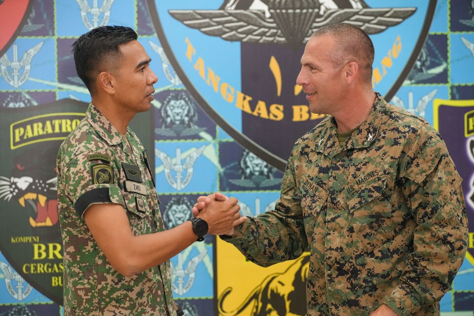 U.S. Marine Corps Col. Sean Dynan, right, commanding officer of the 15th Marine Expeditionary Unit gifts his command challenge coin to Malaysia Army Lt. Col. Mohd Zaki, commanding officer of 18th Battalion, Royal Malay Regiment, 10th Brigade (Para), during a key leader engagement at Sri Pantai Camp, Kuala Terengganu, Malaysia, May 28, 2024. Tiger Strike is a bilateral exercise between U.S. and Malaysia armed forces designed to enhance communication and build combat readiness through combined amphibious operations and subject matter expert exchanges in support of a shared vision for security and stability in the region. (U.S. Marine Corps photo by 1st Lt. Robert Nanna)