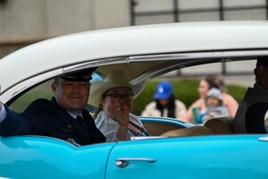 A man waves to a crowd.