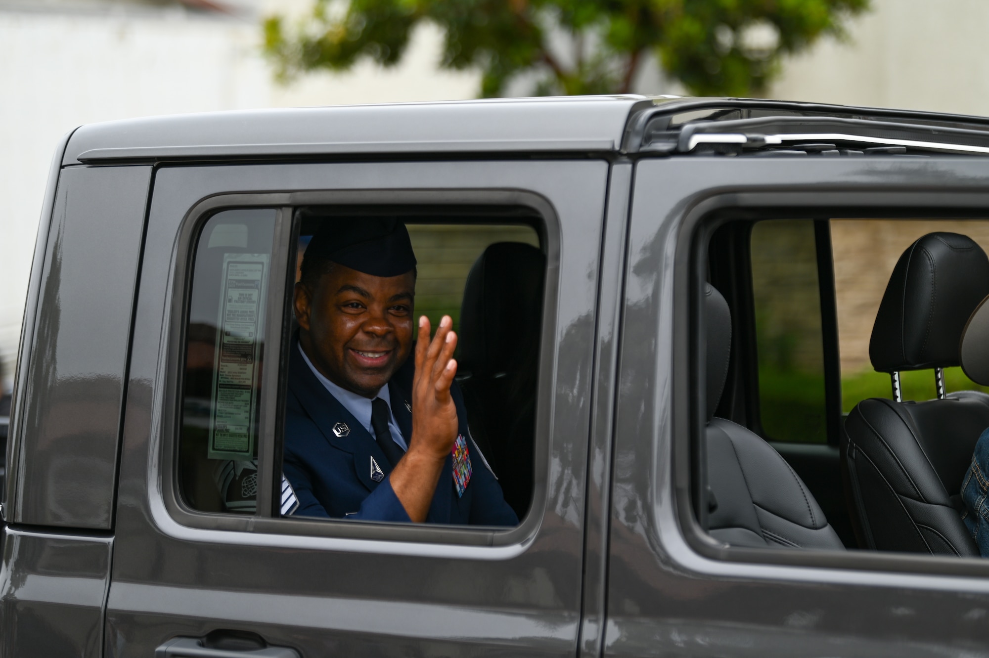 A man waves to a crowd.