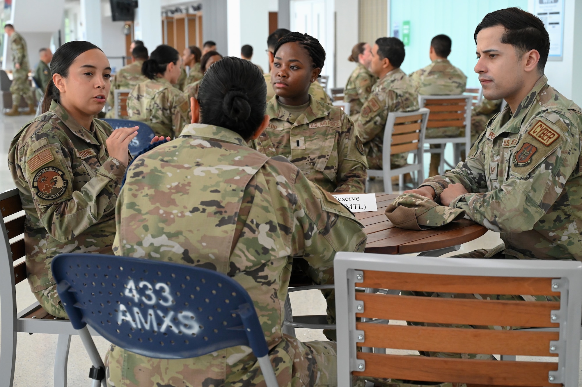 Photo of Senior Airman Devyn De La Torre, 433rd Aerospace Medical Squadron medical logistics specialist, posing a question to Senior Master Sgt. Olga Hudson, Air Force Reserve Command Basic Military Training/Technical Training School Liaison, during a speed mentoring event at Wilford Hall Ambulatory Surgical Center on Joint Base San Antonio-Lackland, Texas