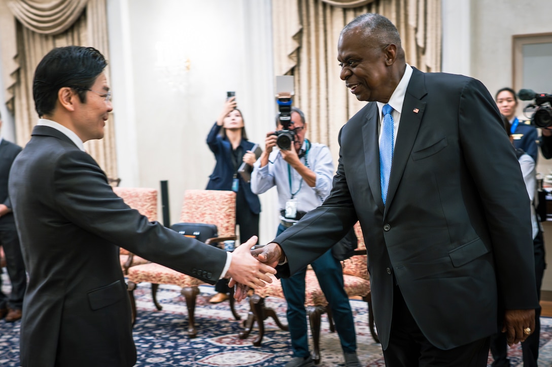 Two people in business attire shake hands.