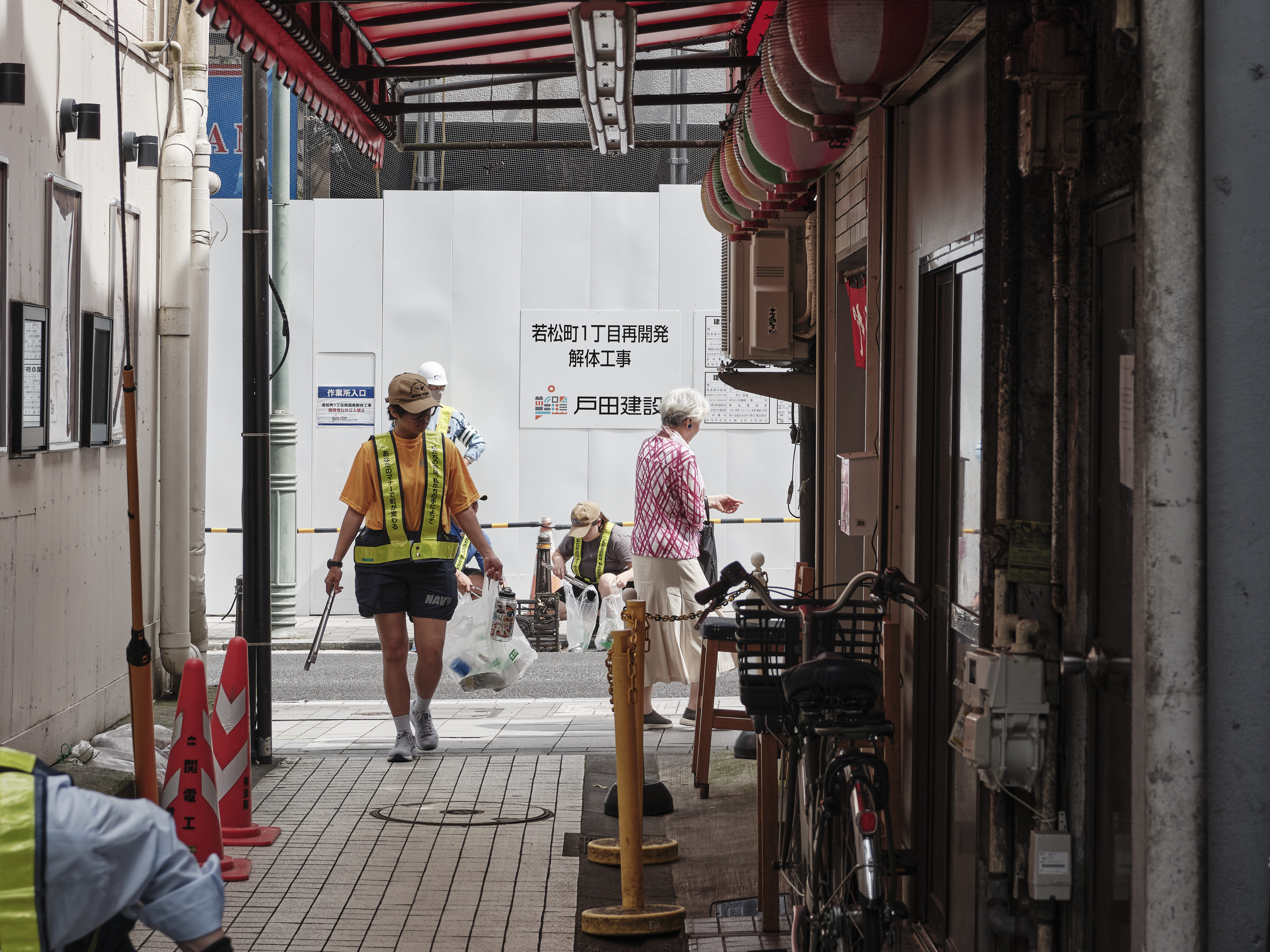 Mass Communication Specialist 3rd Class Alexandria Esteban of Navy Public Affairs Support Element Japan patrols the pedestrian street Sennichidori in Yokosuka, Japan looking for litter May 30, 2024 during the City of Yokosuka's  17th Waste Zero Campaign.