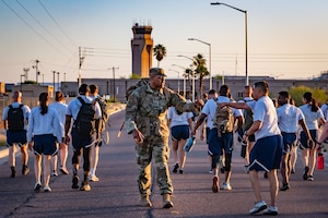 Members of the 944th Fighter Wing honor fallen comrades during a “Fallen Comrade Ruck,” at Luke Air Force Base, Ariz., June 2, 2024. The 944th Top Three organized the event, which saw participants from various squadrons come together, carrying weighted packs or vests for a two-mile trek, starting with a roll call at 5 a.m. Participants also contributed to a food drive, bringing canned goods that were collected at the end of the ruck to be donated to local food banks. This added an element of community service to the commemorative efforts, emphasizing the wing’s commitment to service before self. (U.S. Air Force photo by Tech. Sgt. Tyler J. Bolken)