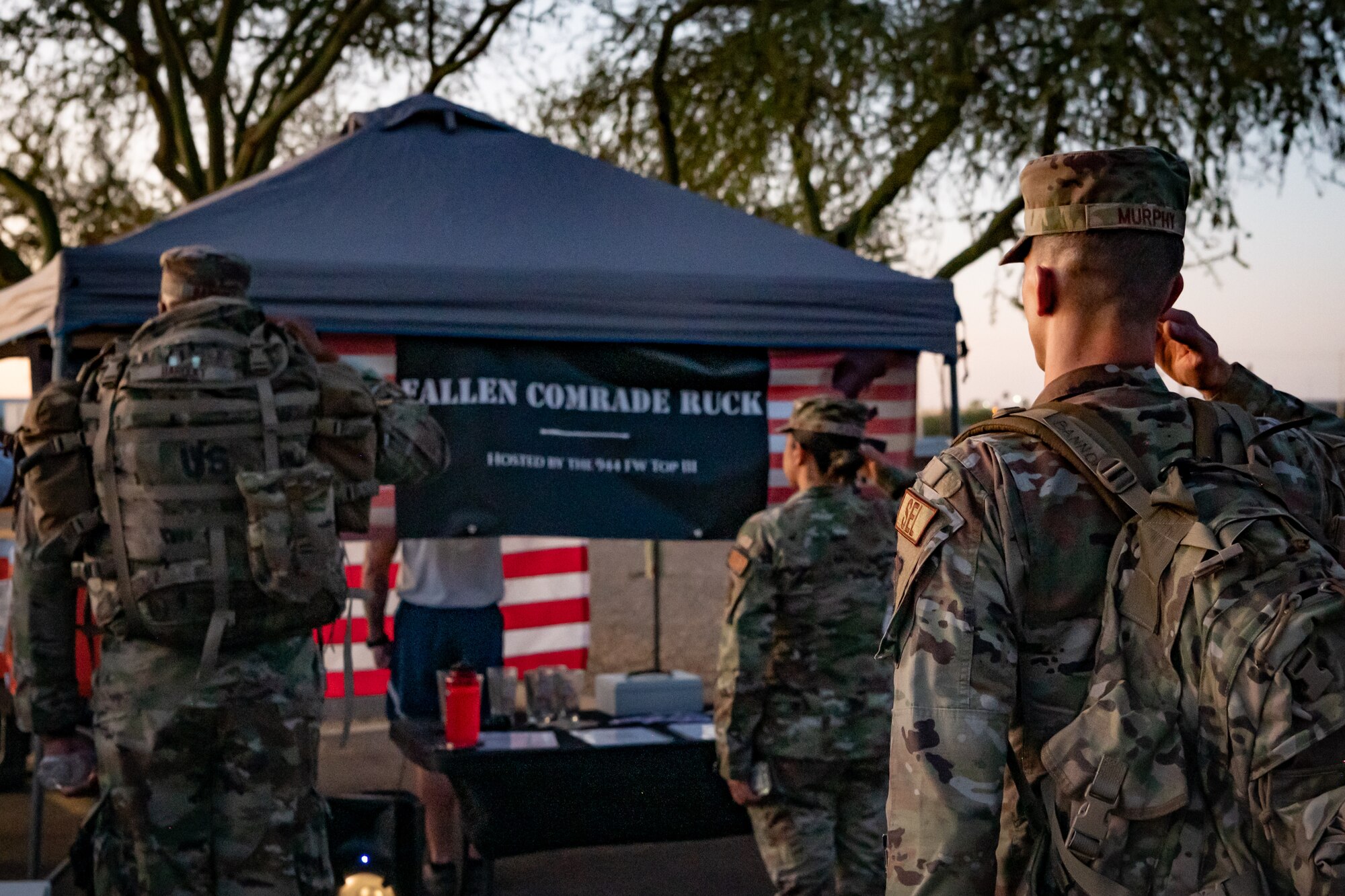 Members of the 944th Fighter Wing honor fallen comrades during a “Fallen Comrade Ruck,” at Luke Air Force Base, Ariz., June 2, 2024. The 944th Top Three organized the event, which saw participants from various squadrons come together, carrying weighted packs or vests for a two-mile trek, starting with a roll call at 5 a.m. Participants also contributed to a food drive, bringing canned goods that were collected at the end of the ruck to be donated to local food banks. This added an element of community service to the commemorative efforts, emphasizing the wing’s commitment to service before self. (U.S. Air Force photo by Tech. Sgt. Tyler J. Bolken)