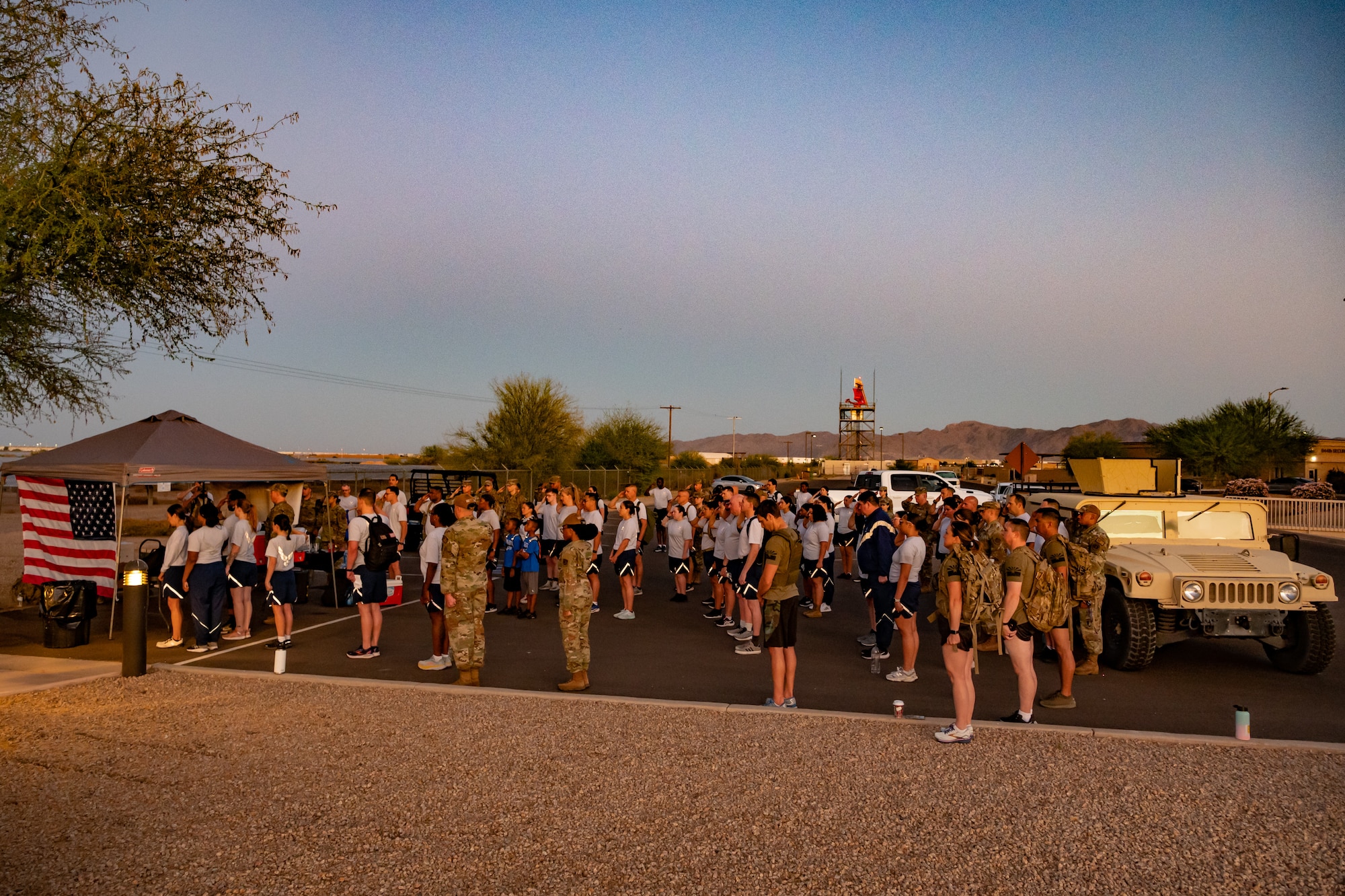 Members of the 944th Fighter Wing honor fallen comrades during a “Fallen Comrade Ruck,” at Luke Air Force Base, Ariz., June 2, 2024. The 944th Top Three organized the event, which saw participants from various squadrons come together, carrying weighted packs or vests for a two-mile trek, starting with a roll call at 5 a.m. Participants also contributed to a food drive, bringing canned goods that were collected at the end of the ruck to be donated to local food banks. This added an element of community service to the commemorative efforts, emphasizing the wing’s commitment to service before self. (U.S. Air Force photo by Tech. Sgt. Tyler J. Bolken)