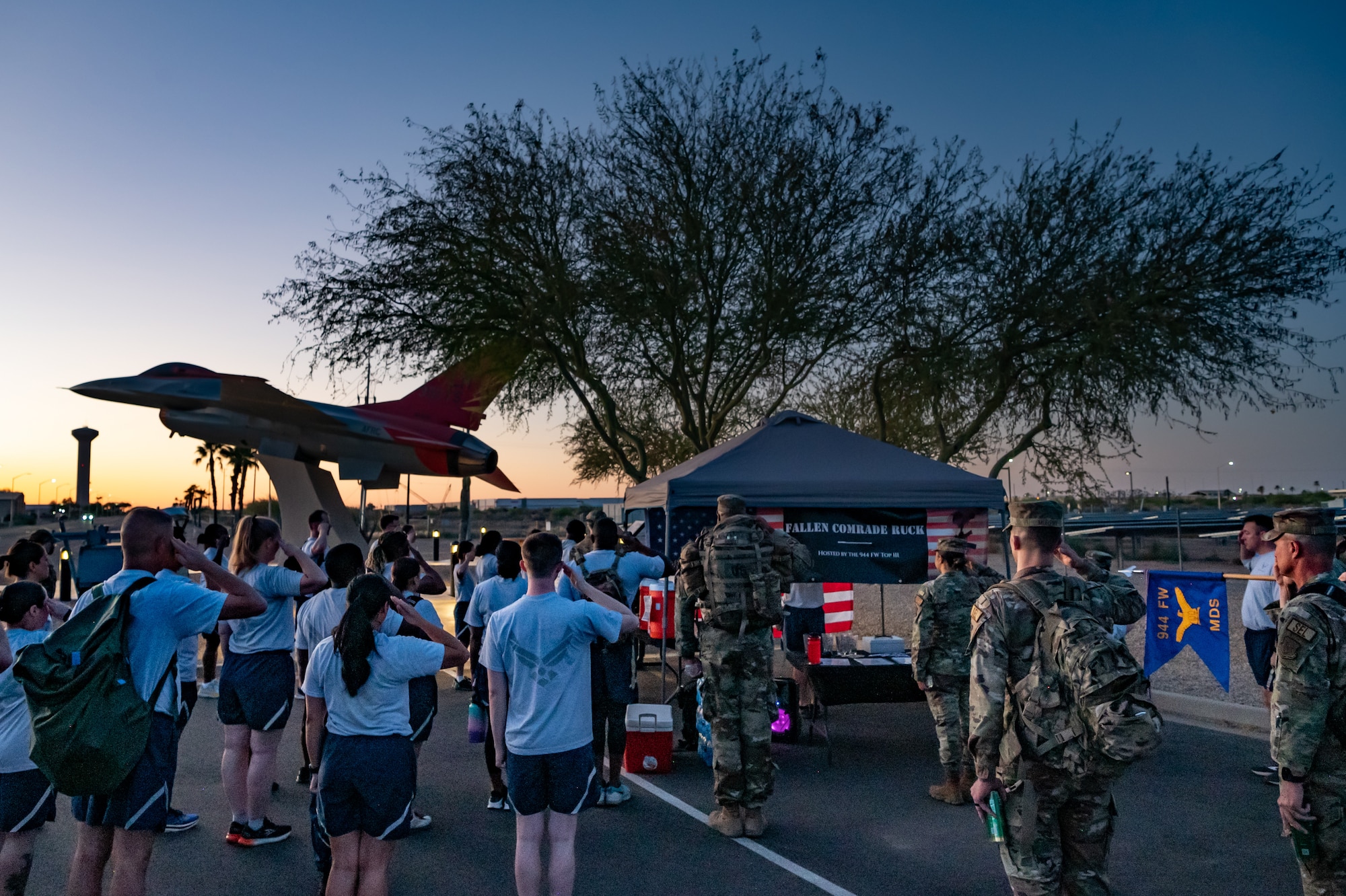 Members of the 944th Fighter Wing honor fallen comrades during a “Fallen Comrade Ruck,” at Luke Air Force Base, Ariz., June 2, 2024. The 944th Top Three organized the event, which saw participants from various squadrons come together, carrying weighted packs or vests for a two-mile trek, starting with a roll call at 5 a.m. Participants also contributed to a food drive, bringing canned goods that were collected at the end of the ruck to be donated to local food banks. This added an element of community service to the commemorative efforts, emphasizing the wing’s commitment to service before self. (U.S. Air Force photo by Tech. Sgt. Tyler J. Bolken)