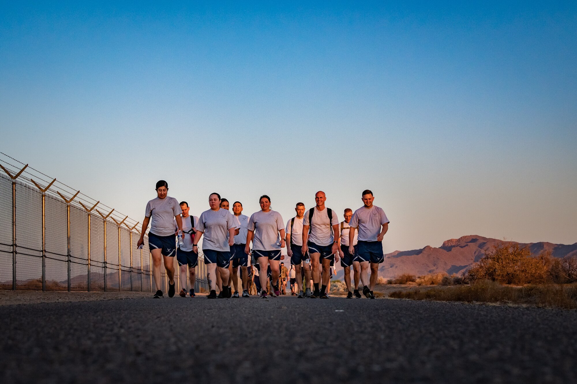 Members of the 944th Fighter Wing honor fallen comrades during a “Fallen Comrade Ruck,” at Luke Air Force Base, Ariz., June 2, 2024. The 944th Top Three organized the event, which saw participants from various squadrons come together, carrying weighted packs or vests for a two-mile trek, starting with a roll call at 5 a.m. Participants also contributed to a food drive, bringing canned goods that were collected at the end of the ruck to be donated to local food banks. This added an element of community service to the commemorative efforts, emphasizing the wing’s commitment to service before self. (U.S. Air Force photo by Tech. Sgt. Tyler J. Bolken)