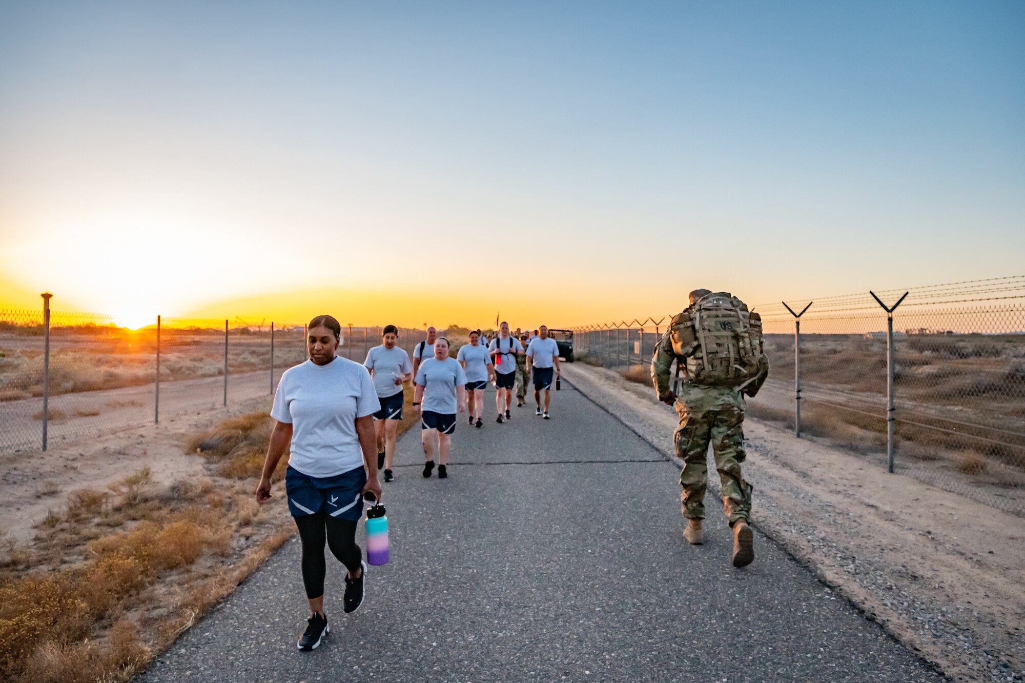 Members of the 944th Fighter Wing honor fallen comrades during a “Fallen Comrade Ruck,” at Luke Air Force Base, Ariz., June 2, 2024. The 944th Top Three organized the event, which saw participants from various squadrons come together, carrying weighted packs or vests for a two-mile trek, starting with a roll call at 5 a.m. Participants also contributed to a food drive, bringing canned goods that were collected at the end of the ruck to be donated to local food banks. This added an element of community service to the commemorative efforts, emphasizing the wing’s commitment to service before self. (U.S. Air Force photo by Tech. Sgt. Tyler J. Bolken)