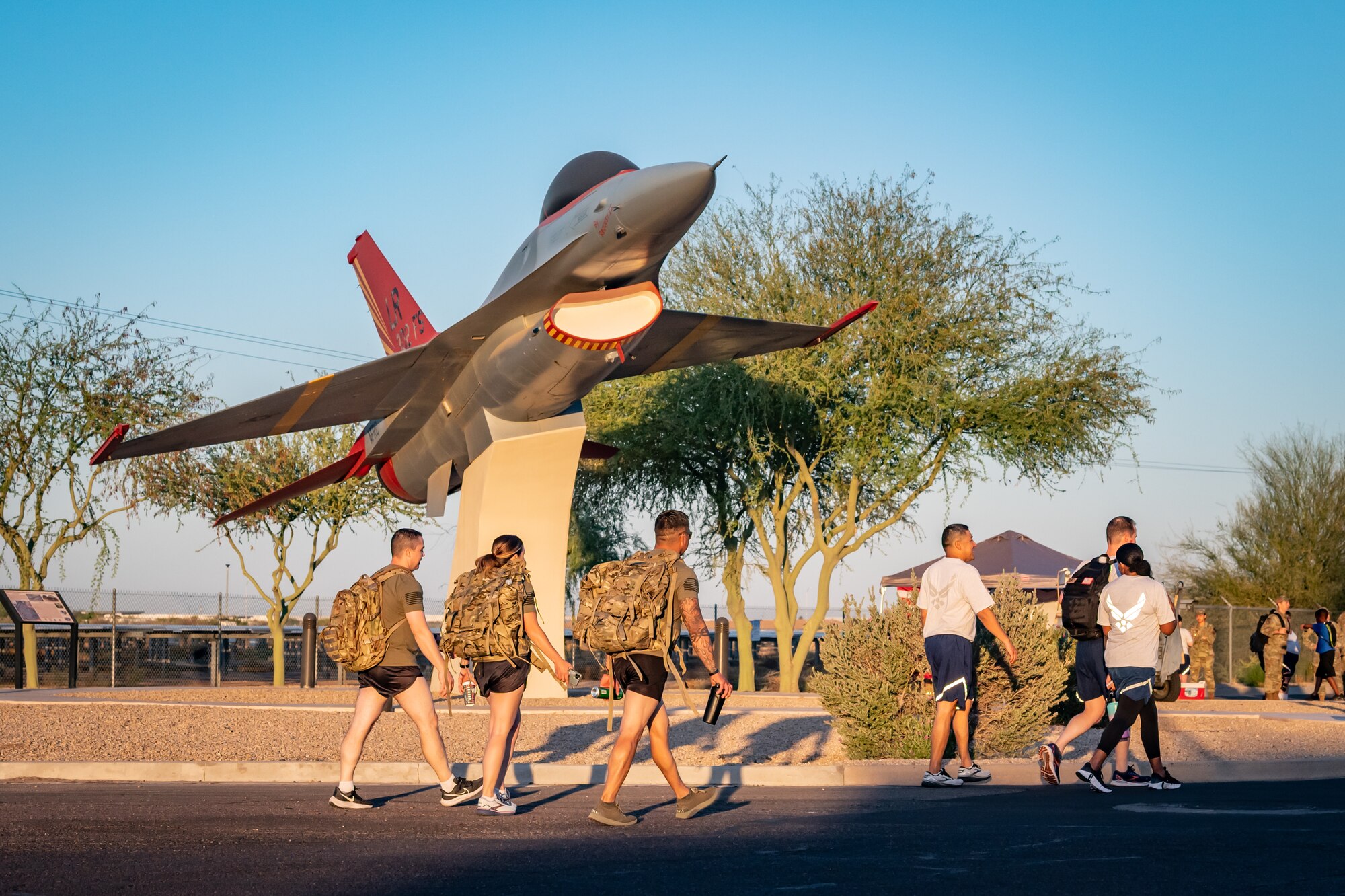 Members of the 944th Fighter Wing honor fallen comrades during a “Fallen Comrade Ruck,” at Luke Air Force Base, Ariz., June 2, 2024. The 944th Top Three organized the event, which saw participants from various squadrons come together, carrying weighted packs or vests for a two-mile trek, starting with a roll call at 5 a.m. Participants also contributed to a food drive, bringing canned goods that were collected at the end of the ruck to be donated to local food banks. This added an element of community service to the commemorative efforts, emphasizing the wing’s commitment to service before self. (U.S. Air Force photo by Tech. Sgt. Tyler J. Bolken)