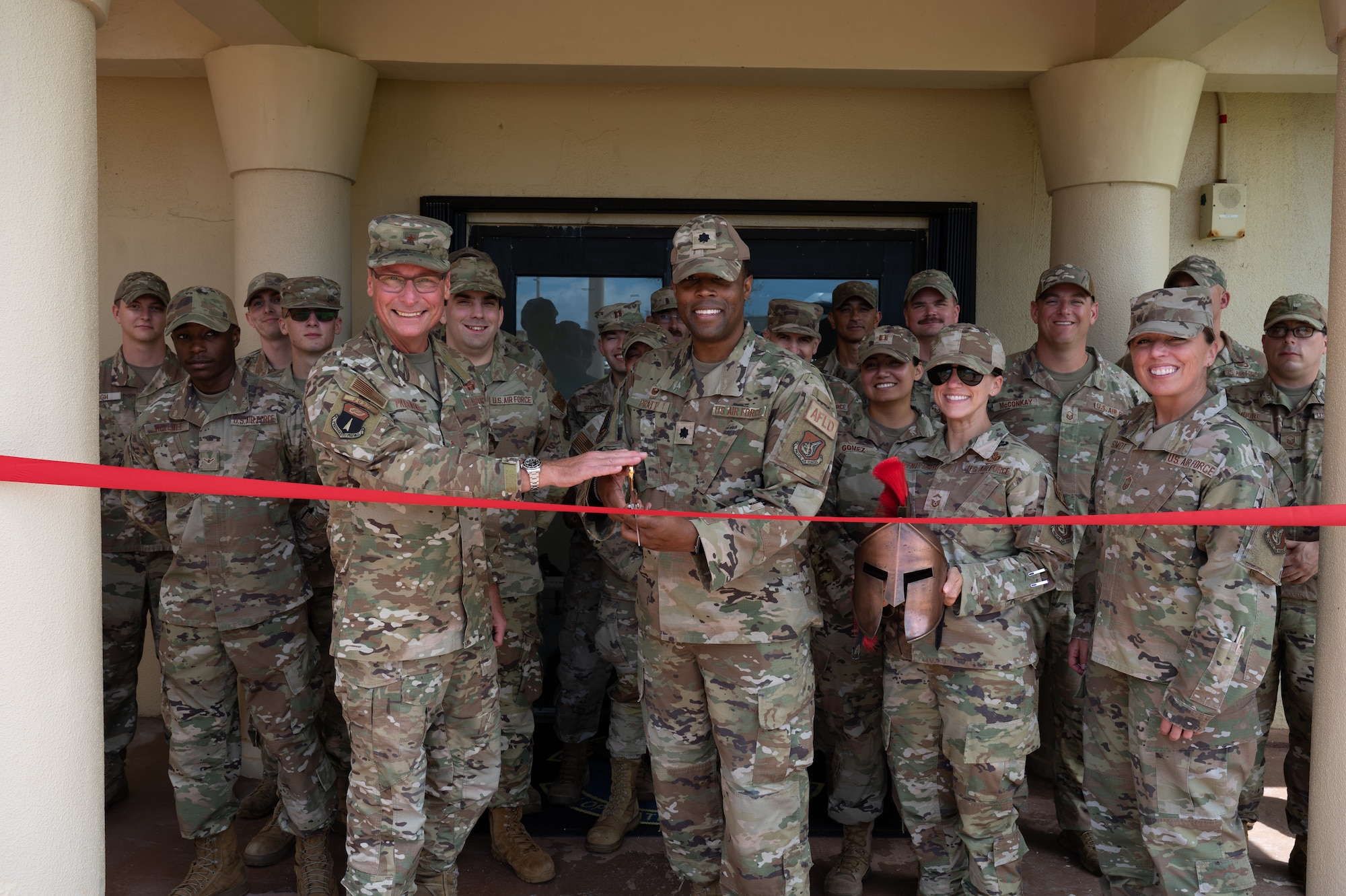 U.S. Air Force Brig. Gen. Thomas Palenske, 36th Wing commander, and Lt. Col. Edwin Pratt, 36th Operations Support Squadron commander, participates in a ribbon cutting for the re-opening of the 36th OSS offices at Andersen Air Force Base, Guam, May. 29, 2024. It has almost been a year since the OSS had to find refuge in other offices since the severe damage caused by Typhoon Mawar. The squadron has now returned to their home next to the Andersen passenger terminal, which is being repaired as well. (U.S. Air Force photo by Airman 1st Class Manasseh Demissie)