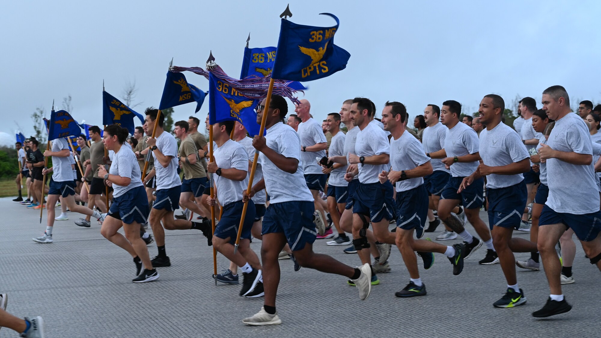 36th Squadron guidon bearers lead a 5K Run for Memorial Day at the Pacific Regional Training Center-Andersen, Guam, May 24, 2024. Airmen from across Andersen Air Force Base, Guam, joined together for this memorial run to honor the service members that came before them. (U.S. Air Force photo by Senior Airman Akeem Campbell)