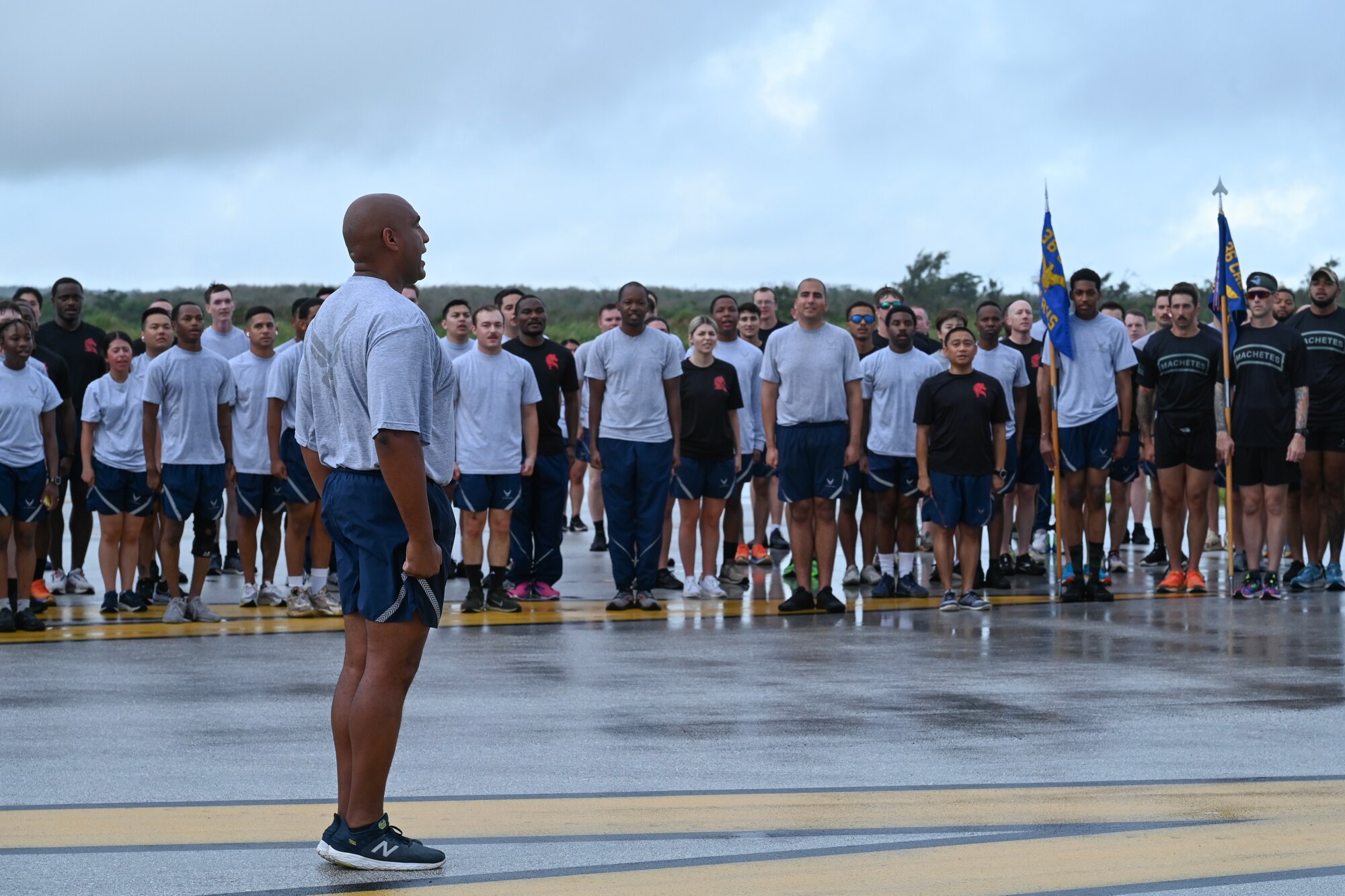 Col. Larry Fenner, 36th Wing vice commander, leads the Air Force Song with 36th Wing Airmen at the Pacific Regional Training Center-Andersen, Guam, May 24, 2024. Airmen from across Andersen Air Force Base, Guam, joined together for a memorial run to honor the service members that came before them. (U.S. Air Force photo by Senior Airman Akeem Campbell)