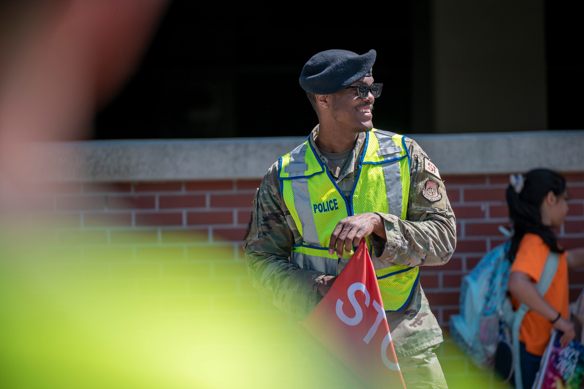 U.S. Air Force Senior Airman Curtis King, 51st Security Forces Squadron defense operations center controller journeyman, monitors traffic after a student school release at Osan Air Base, Republic of Korea, May 31, 2024. The 51st SFS crossing guards monitor and direct traffic for arriving and departing students from Osan Elementary School and Osan Middle High School. (U.S. Air Force photo by Senior Airman Sabrina Fuller-Judd)