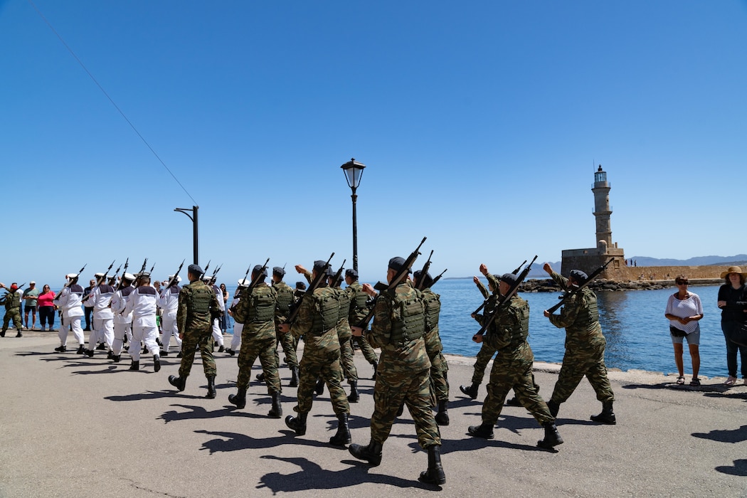 Service members of the Hellenic armed forces march in formation outside the Firka Fortress on the Venetian Harbor in Chania, Crete, Greece, on May 24, 2024. Capt. Odin J. Klug (not pictured), commanding officer, Naval Support Activity Souda Bay, joined service members from the Hellenic, United Kingdom, Australia, and New Zealand armed forces during a ceremonial flag-raising to mark the 83rd anniversary of the battle to defend Crete against the Nazi invasion.
