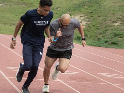U.S. Army Veteran Sgt. 1st Class Henry Escobedo practices sprinting with his running guide Preston Gantt at the 2024 Army Trials, Fort Liberty, North Carolina