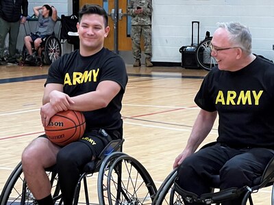 Capt. Nate Degen gets a laugh out of CW3 Kirk Holden as they strategize before a wheelchair basketball scrimmage at the 2024 Army Trials