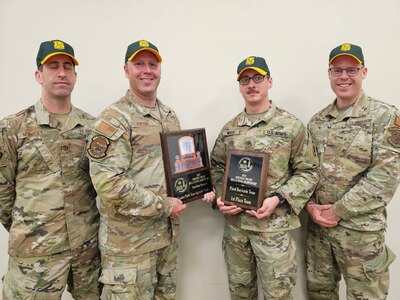 U.S. Army Soldiers and Airmen with the small arms readiness training section, Vermont National Guard, pose with their awards after the Winston P. Wilson Small Arms Championship