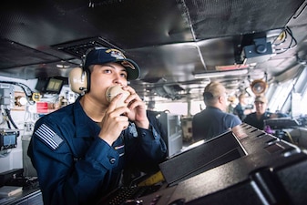 OSSN Kevin RamosGonzales stands watch aboard USS Ronald Reagan (CVN 76) in the Philippine Sea.