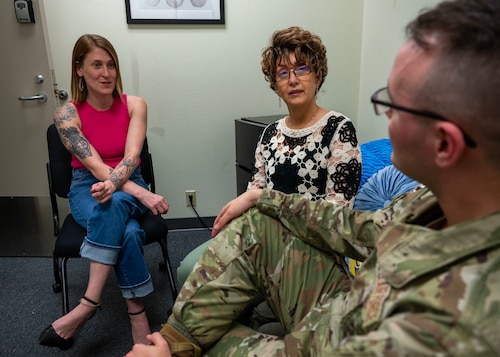 Annaka Drouin, 17th Training Wing Integrated Resilience Officer prevention specialist, and Teresa Shipman, 17th TRW IRO director, speak with an Airman about resiliency at Goodfellow Air Force Base, Texas, May 30, 2024. IRO aims to effectively address prevention and resiliency through coordinated efforts, ultimately fortifying the capability and preparedness of military members. (U.S. Air Force photo by Senior Airman Sarah Williams)