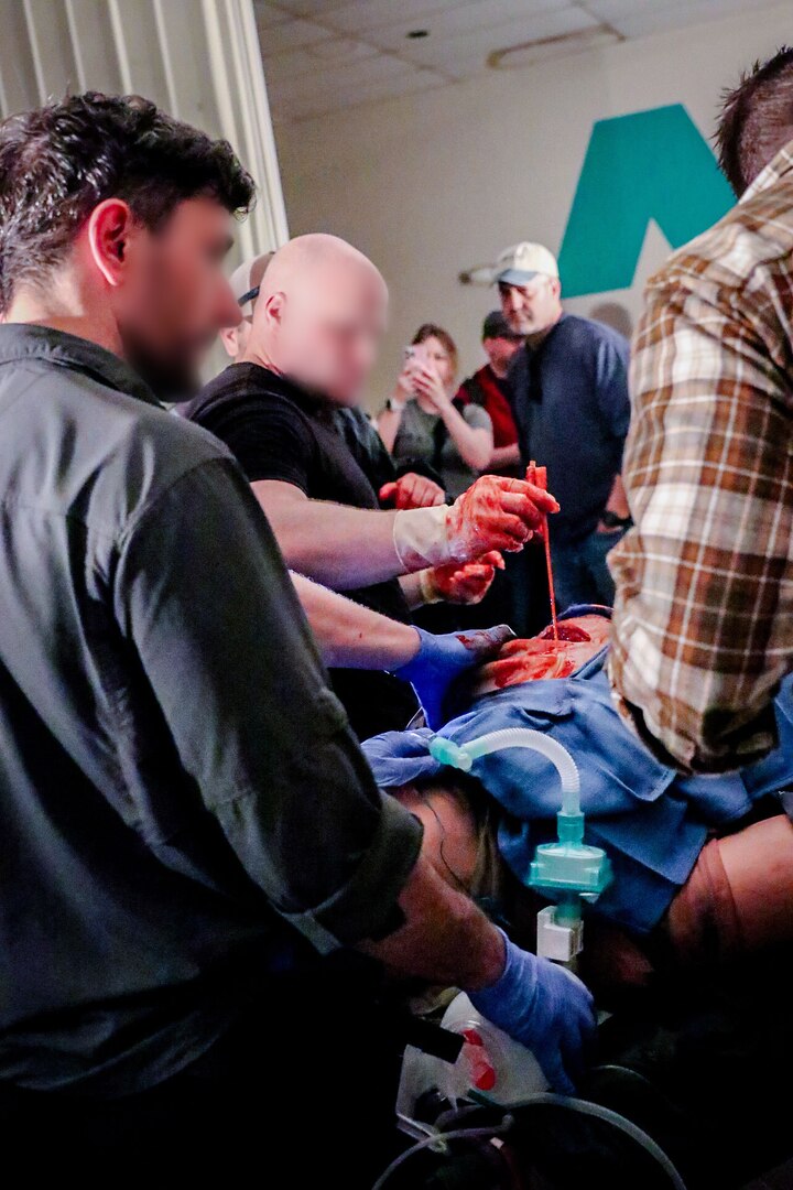 A surgeon from the 2nd Battalion, 19th Special Forces Group (Airborne), West Virginia National Guard, conducts surgery on a mock patient with assistance from members of the United Kingdom's 3 Ranger Special Operations Resuscitation Team during the West Virginia National Guard-led Ridge Healer exercise held in late April throughout West Virginia. Ridge Healer is a medical exercise that provides the special operations community with irregular warfare medical resiliency and resistance training in austere, complex, contested, and denied environments. (U.S. Air National Guard photo by Lt. Col. Holli Nelson)