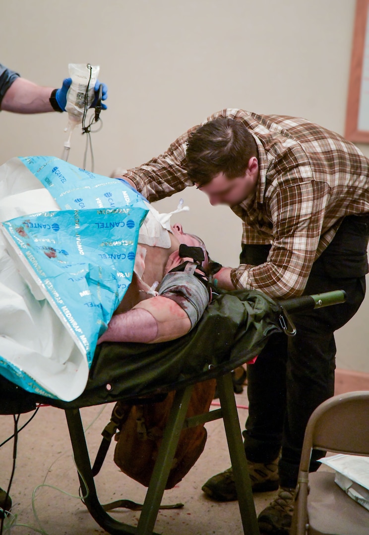 A soldier assigned to the United Kingdom's 3 Ranger Special Operations Resuscitation Team or SORT assists in monitoring a mock patient in a clandestine medical facility during the West Virginia National Guard-led Ridge Healer exercise held in late April throughout West Virginia. Ridge Healer is a medical exercise which provides the special operations community with irregular warfare medical resiliency and resistance training in austere, complex, contested and denied environments. (U.S. Air National Guard photo by Lt. Col. Holli Nelson)