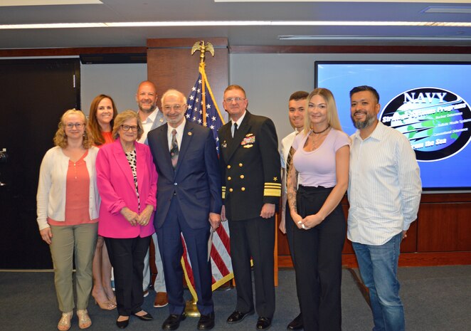 Vice Adm. Johnny Wolfe Jr., director Strategic Systems Programs (fourth from right), presented Mr. Mike Coussa, EMCUBE (fifth from right), with a 50-year FBM Service Award at the biannual Steering Task Group Meeting, 22 May. Fifty-year FBM Service Awards celebrate the career-long achievements and commitments of industry and government personnel who have support the FBM program for over 50 years. (U.S. Navy photo by Joseph Ross/Released)