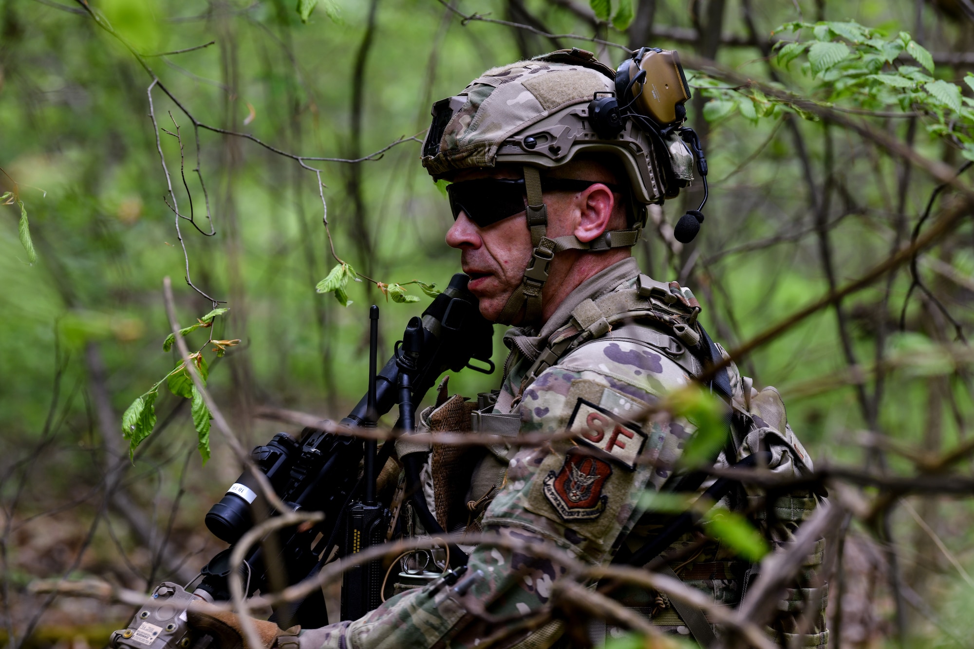 Tech. Sgt. Stephen Holland, a fire team leader assigned to the 910th Security Forces Squadron, checks the perimeter of an area during a training exercise at Camp James A. Garfield Joint Military Training Center, Ohio, May 4, 2024.