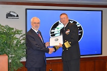 Vice Adm. Johnny Wolfe Jr., director Strategic Systems Programs, presented Mr. Randy York, Arcfield, with a 50-year FBM Service Award at the biannual Steering Task Group Meeting, 22 May. Fifty-year FBM Service Awards celebrate the career-long achievements and commitments of industry and government personnel who have support the FBM program for over 50 years. (U.S. Navy photo by Joseph Ross/Released)