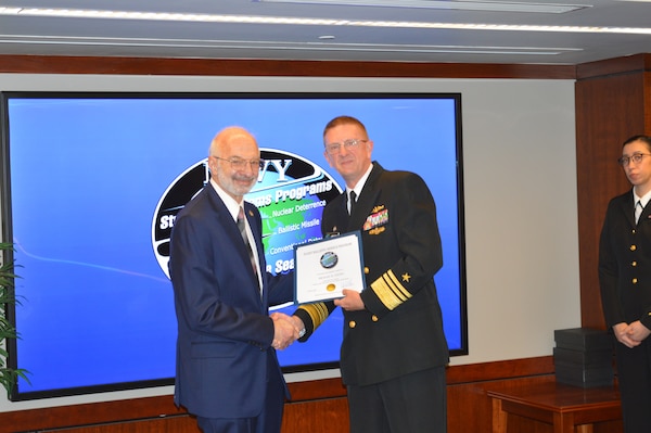 Vice Adm. Johnny Wolfe Jr., director Strategic Systems Programs, presented Mr. Mike Coussa, EMCUBE, with a 50-year FBM Service Award at the biannual Steering Task Group Meeting, 22 May. Fifty-year FBM Service Awards celebrate the career-long achievements and commitments of industry and government personnel who have support the FBM program for over 50 years. (U.S. Navy photo by Joseph Ross/Released)