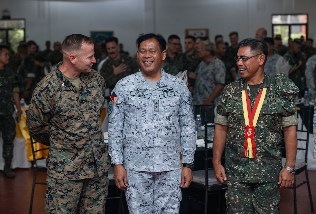 U.S. Marine Corps Col. Stuart Glenn, left, commanding officer of the 13th Marine Expeditionary Unit, Philippine Navy Rear Adm. Alfonso Torres, center, commander, Armed Forces Philippines Western Command, and Philippine Marine Corps Brig. Gen. Romeo T. Racadio, director representative, Exercise Directorate Headquarters, speak during the Marine Aviation Support Activity opening ceremony at Fort Bonifacio, Manila, Philippines, June 3, 2024.