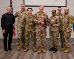 The base Chaplain Corps Team pose for a group photo at main chapel.