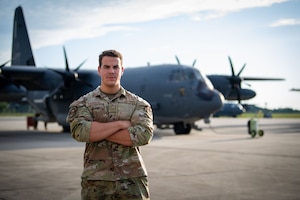 U.S. Air Force Senior Airman Dalton Chambers assigned to the 71st Rescue Generation Squadron poses for a photo in front of an HC-130J Combat King II at Moody Air Force Base, Georgia, May 30, 2024. As a crew chief, Chambers is responsible for the maintenance and overall condition of an aircraft to enable agile combat employment of U.S. Air Force assets. (U.S. Air Force photo by 2nd Lt. Benjamin Williams)