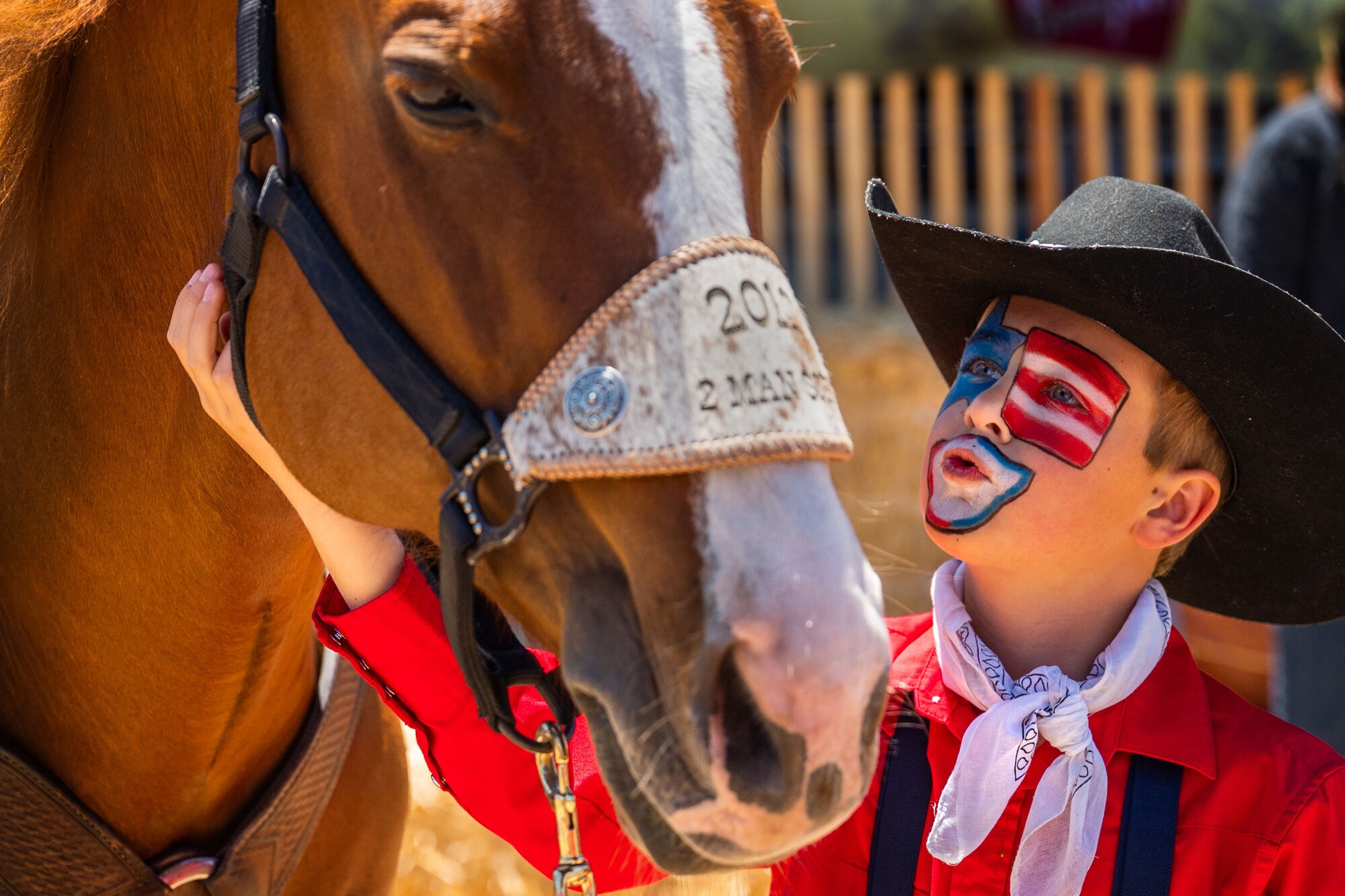 A young rodeo participant greets a horse during the Santa Maria Elks Rodeo in Santa Maria.