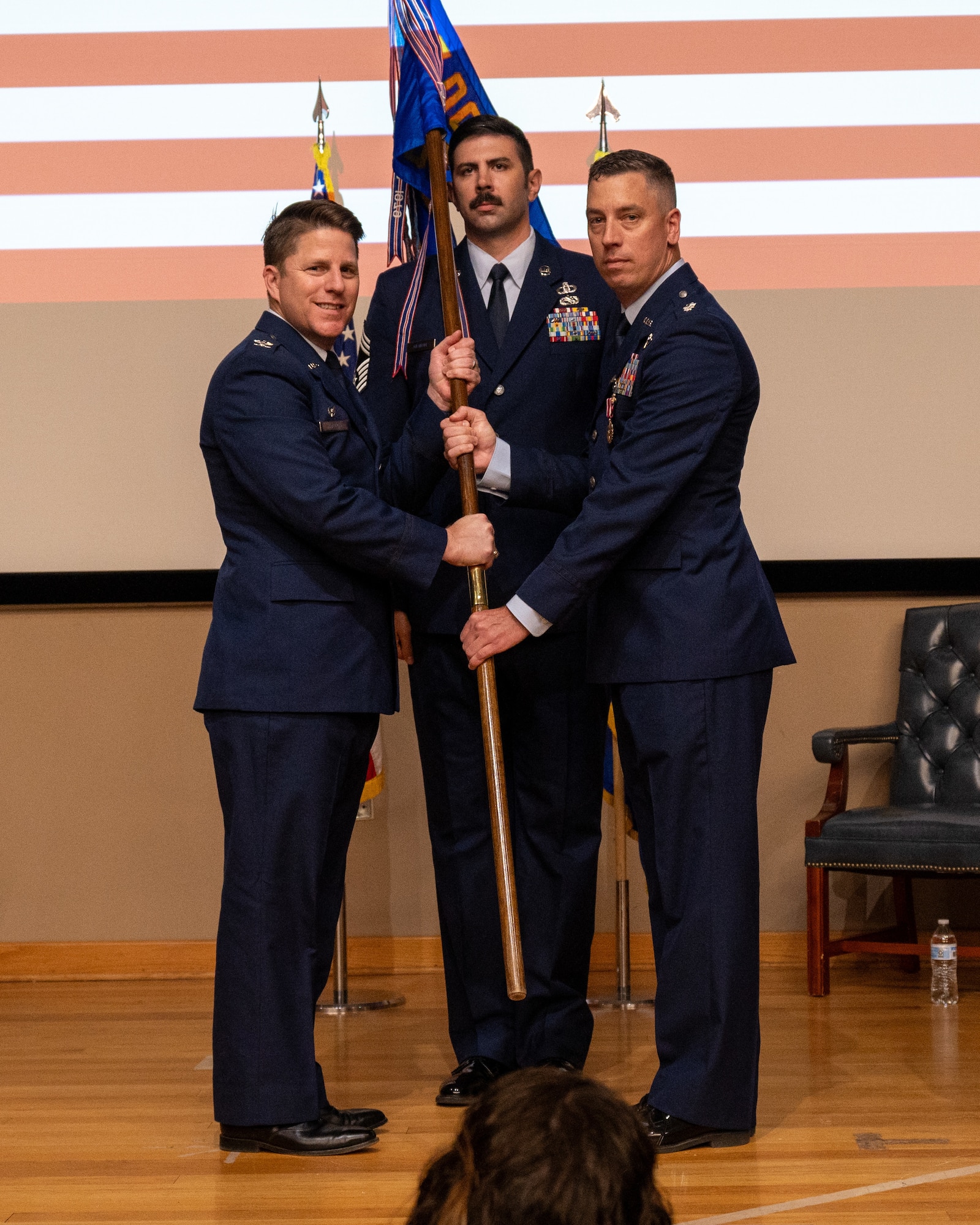 U.S. Air Force Col. James Blech, 47th Operations Group commander, accepts the guidon from Lt. Col. Matthew Kless, former 47th Operations Support Squadron commander, during the change of command ceremony at Laughlin Air Force Base, Texas, May 29, 2024. Change of command ceremonies represent a formal transfer of authority and responsibility for a unit from one commanding officer to another. (U.S. Air Force photo by Staff Sgt. Nicholas Larsen)