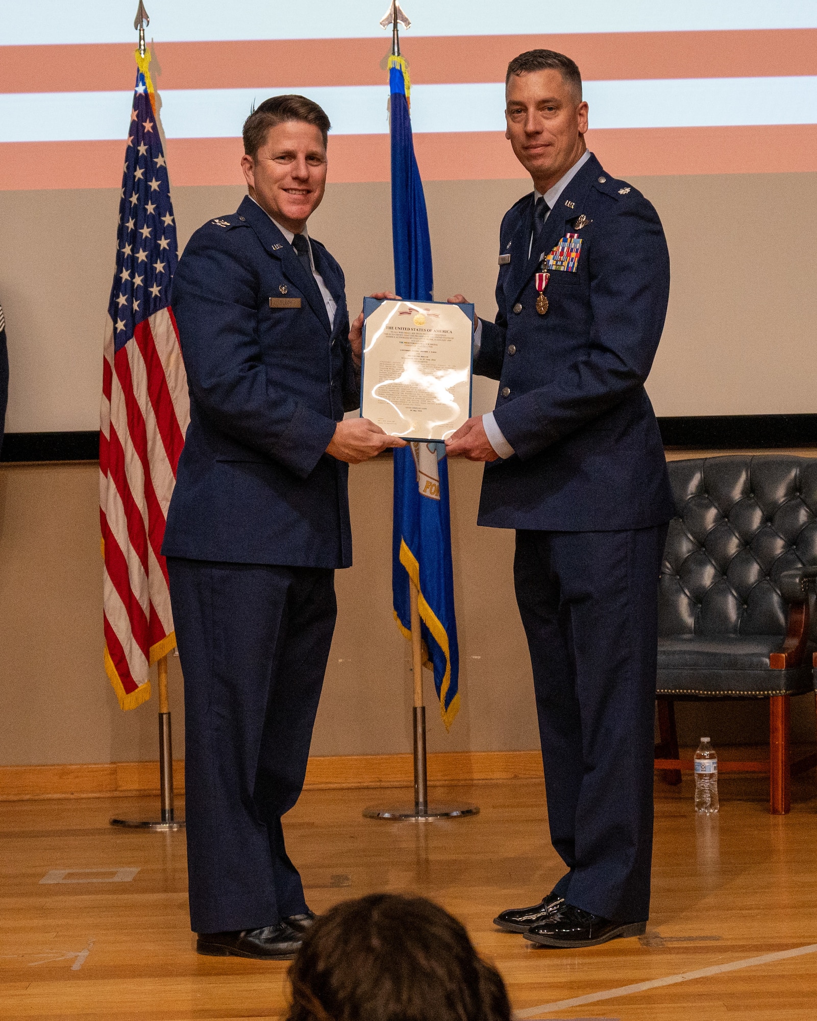 U.S. Air Force Col. James Blech, 47th Operations Group commander, presents the meritorious service medal to Lt. Col. Matthew Kless, 47th Operations Support Squadron commander, during the change of command ceremony at Laughlin Air Force Base, Texas, May 29, 2024. The Meritorious Service Medal was established as the counterpart of the Bronze Star Medal for the recognition of meritorious noncombatant service. (U.S. Air Force photo by Staff Sgt. Nicholas Larsen)