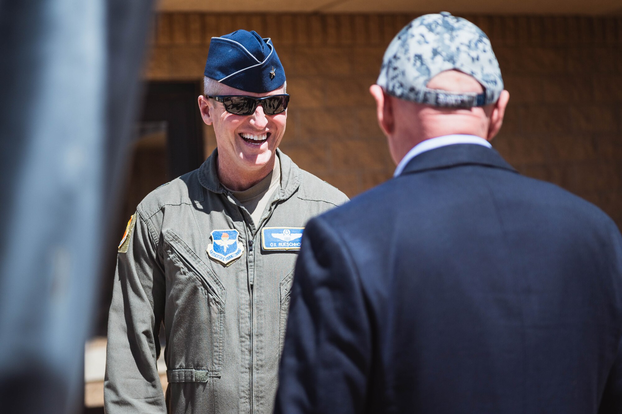 U.S. Air Force Brig. Gen. Jason M. Rueschhoff, 56th Fighter Wing commander, speaks with U.S. Senator Mark Kelly following a conference room brief.