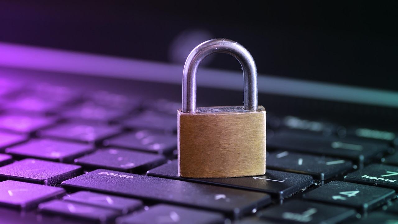 A padlock sits on a keyboard.