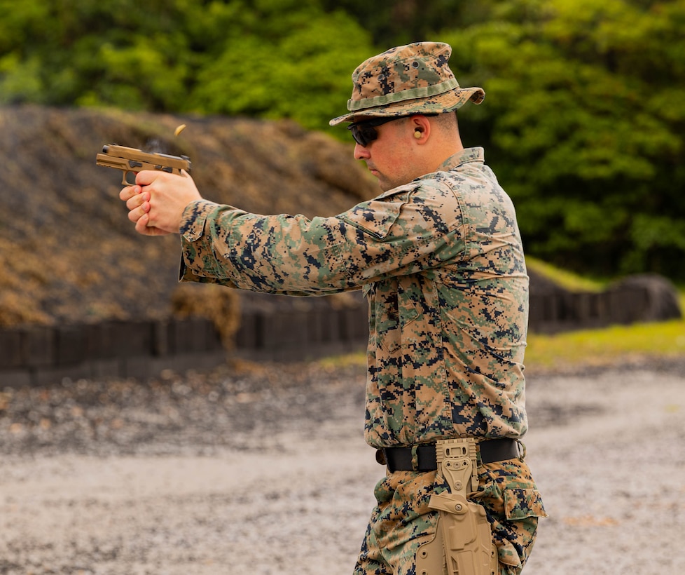 U.S. Marine Corps Sgt. Samuel Berkheimer, a fires support system operator with the 3rd Marine Expeditionary Brigade, fires an M18 service pistol during an intramural pistol competition on Camp Hansen, Okinawa, Japan, May 23, 2024. The multi-day competition developed pistol marksmanship, exercised technical and tactical proficiency, and improved skills and confidence with the M18 service pistol. Berkheimer is a native of Maryland. (U.S. Marine Corps photo by 1st Lt. Samuel H. Barge)