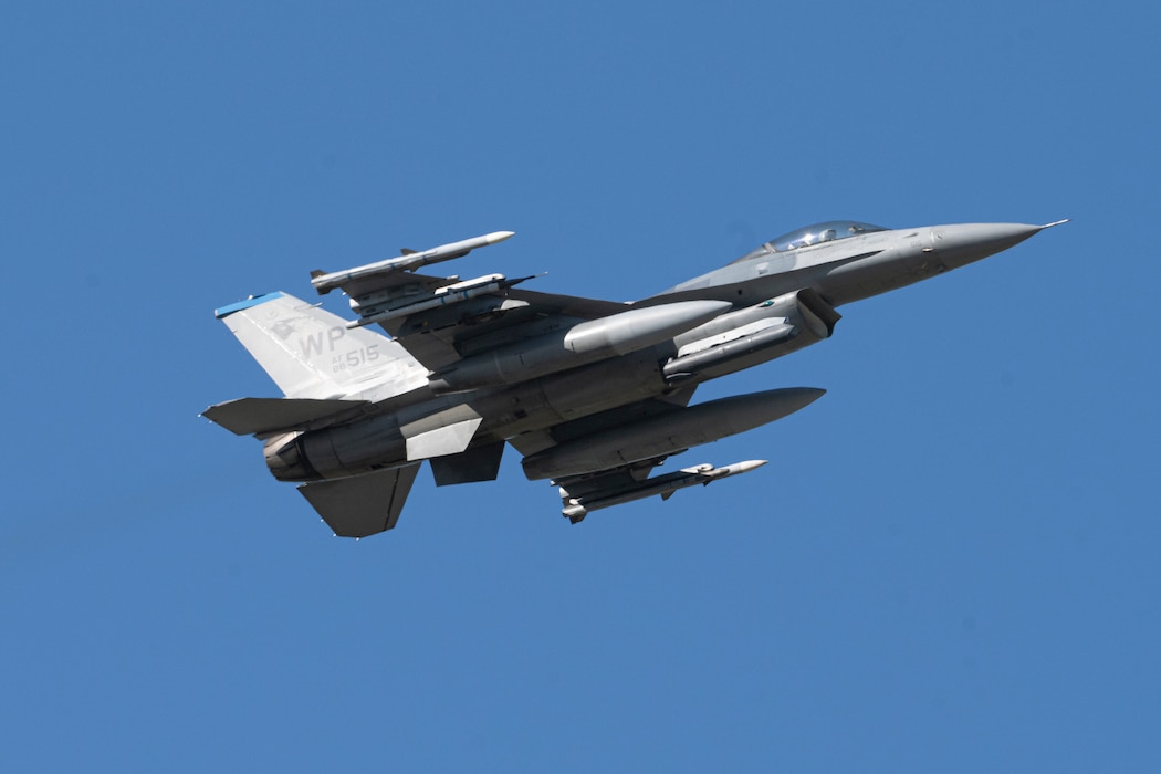 A F-16 Fighting Falcon aircraft flies in the sky.
