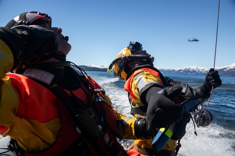 Alaska Air National Guard pararescuemen from the 212th Rescue Squadron observe a 210th Rescue Squadron HH-60G Pave Hawk helicopter during underway hoist training in the Prince William Sound near Whittier, Alaska, May 15, 2024. The Airmen of the 212th RQS are trained, equipped, and postured to conduct full-spectrum personnel recovery to include both conventional and unconventional rescue operations. The 212th, along with the 210th and 211th RQSs, make up the 176th Wing Rescue Triad and are among the busiest combat search and rescue units in the world. (Alaska National Guard photo by Alejandro Peña)