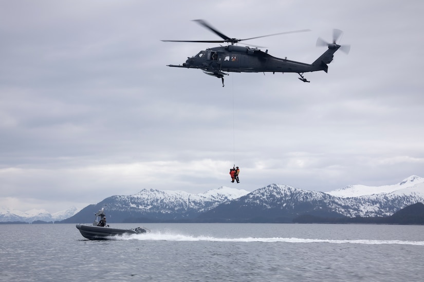 Alaska Air National Guard HH-60G Pave Hawk helicopter aviators assigned to the 210th Rescue Squadron hoist two 212th Rescue Squadron pararescuemen during underway hoist training in the Prince William Sound near Whittier, Alaska, May 16, 2024. The Airmen of the 212th RQS are trained, equipped, and postured to conduct full-spectrum personnel recovery to include both conventional and unconventional rescue operations. The 212th, along with the 210th and 211th RQSs, make up the 176th Wing Rescue Triad and are among the busiest combat search and rescue units in the world. (Alaska National Guard photo by Alejandro Peña)