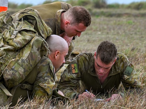 The Royal Australian Air Force team plot the coordinates during the Combat Tactics, Endurance and Agility Assessment at the Pacific Regional Training Center-Andersen, Guam, May 23, 2024. The RAAF was one of three international teams that participated in the 7th Annual Advanced Combat Skills Assessment hosted by the Pacific Air Forces.  Besides Australia, the United Kingdom and Japan sent their own representatives. (U.S. Air Force photo by Airman 1st Class Natasha Ninete)