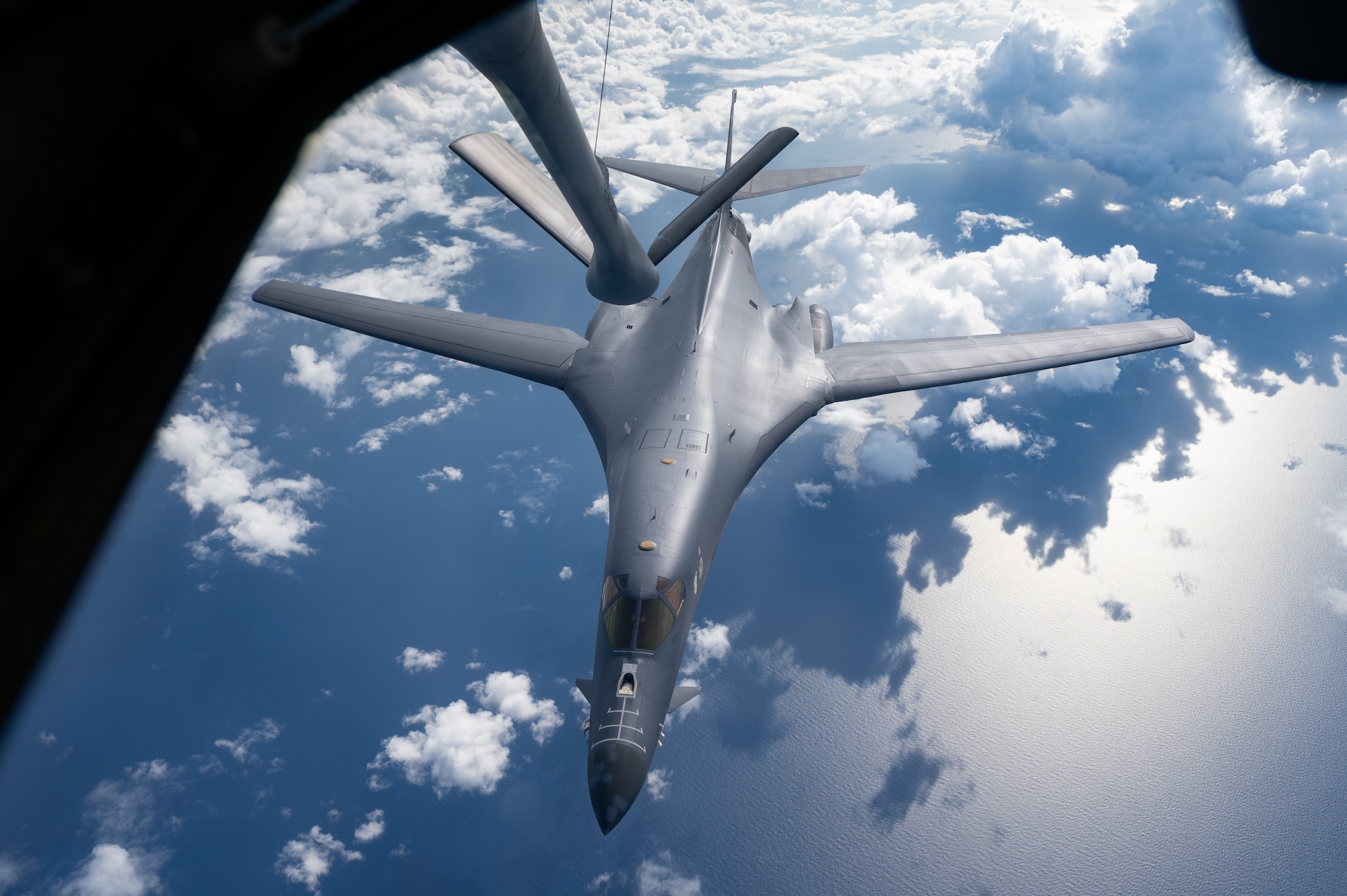 A U.S. Air Force B-1B Lancer assigned to the 37th Expeditionary Bomb Squadron, Ellsworth Air Force Base, S.D., approaches a 909th Air Refueling Squadron KC-135 Stratotanker to conduct aerial refueling during a bomber task force mission over the South China Sea, May 31, 2024. Bomber missions enhance readiness, to include joint and multi-lateral, to respond to any potential crisis or challenge in the Indo-Pacific. (U.S. Air Force photo by Senior Airman Tylir Meyer)