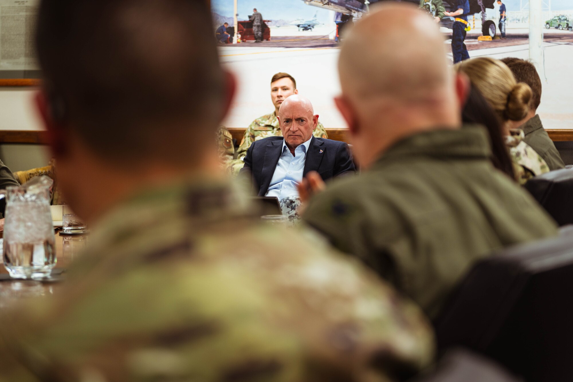 U.S. Senator Mark Kelly, listens to U.S. Air Force Col. Nicholas Ihde, F-35 Lightning II Joint Program Office USAF service deputy, during a brief.